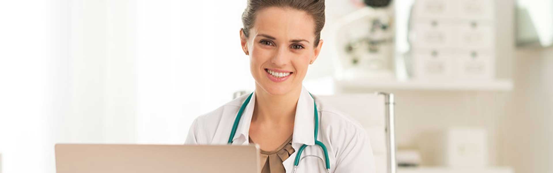 happy physician with laptop