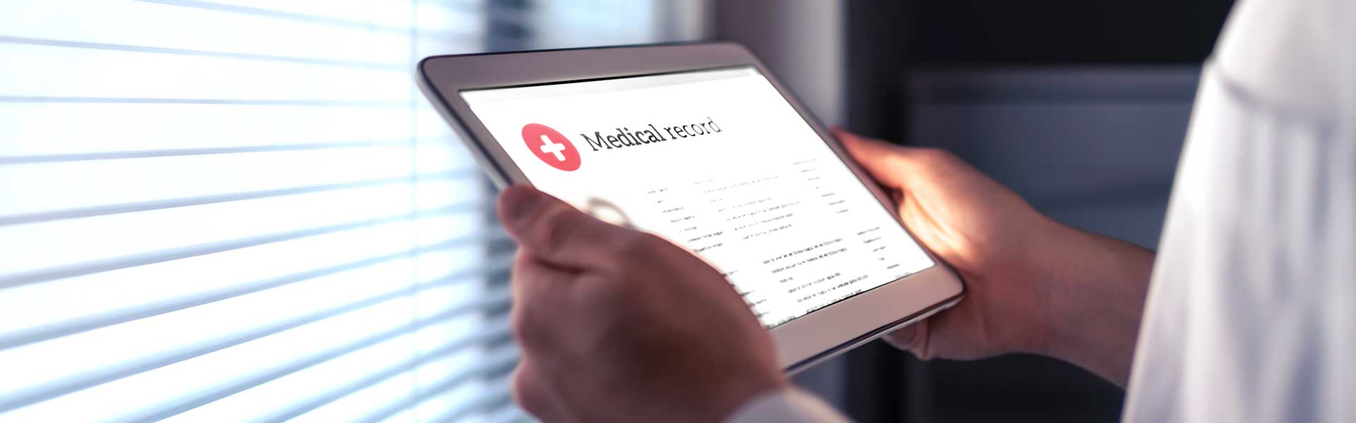 physician-viewing-medical-records-on-tablet